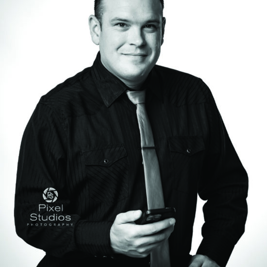 black and white professional business headshot photo of man smiling