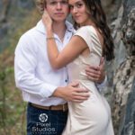 Sexy couples image of a young couple outside near some beautiful rock wall and green bushes. Black Hills Photography Laurel Danley